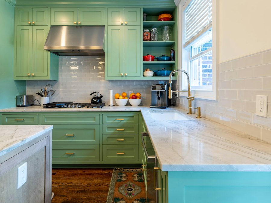 Sage green cabinets with marble countertops